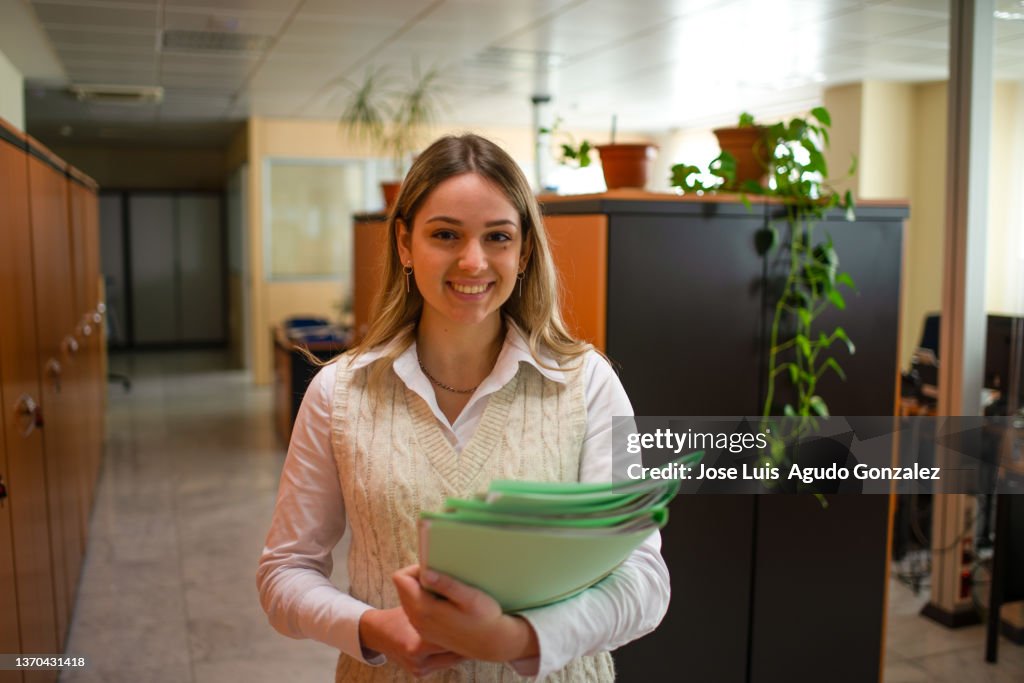 Smiling office working with documents in workplace