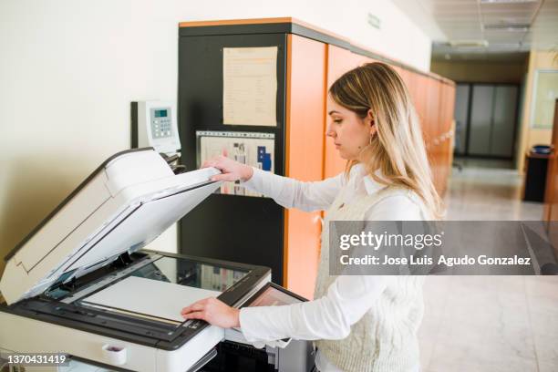 office worker copying document on printer - copier stock pictures, royalty-free photos & images