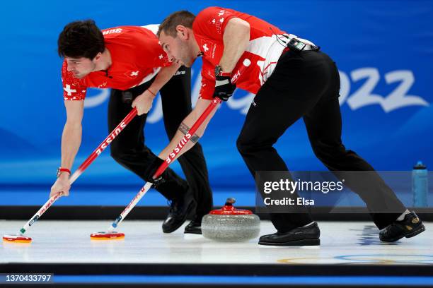 Sven Michel and Benoit Schwarz of Team Switzerland compete against Team Great Britain during the Men’s Curling Round Robin Session on Day 10 of the...