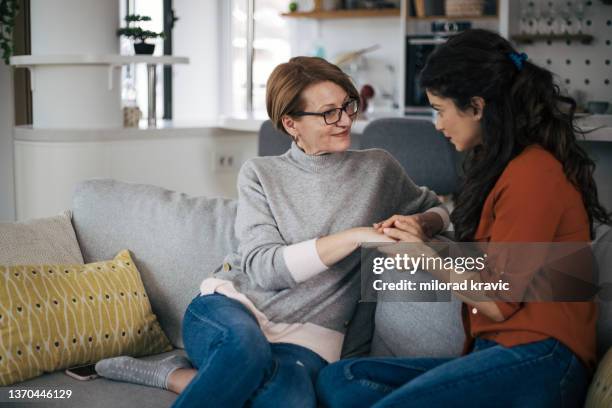 mother and daughter talking to each other and holding hands - frustrated parent stock pictures, royalty-free photos & images