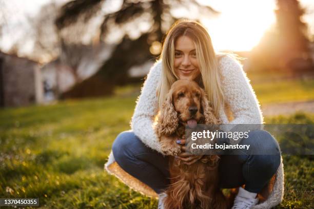 portrait of happy friends enjoying sunset in park - cocker spaniel bildbanksfoton och bilder