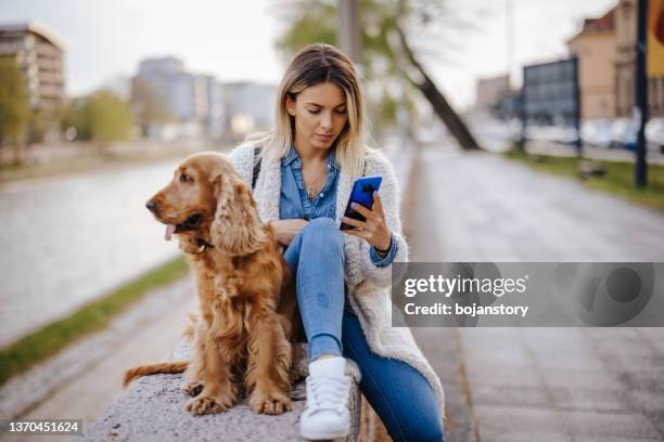 best friends enjoying sunny spring day on city quay - spring city break stock pictures, royalty-free photos & images