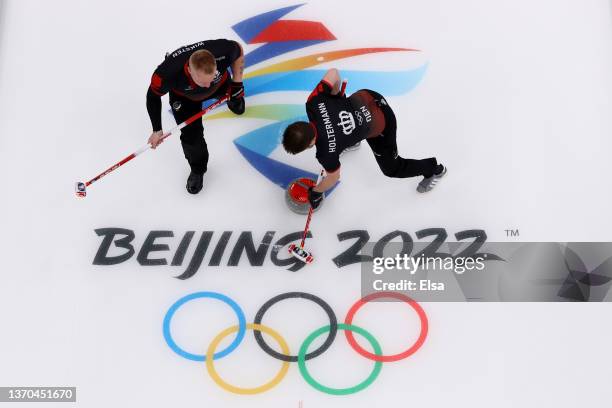 Henrik Holtermann and Kasper Wiksten of Team Denmark compete against Team Norway during the Men’s Curling Round Robin Session on Day 10 of the...