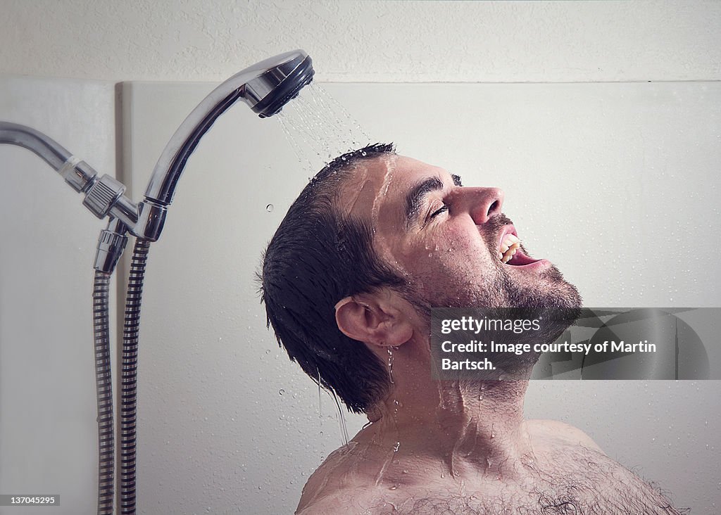 Man taking bath with help of shower