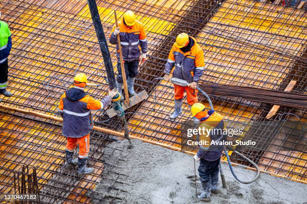 concrete pouring on the construction site. - building foundations stock pictures, royalty-free photos & images