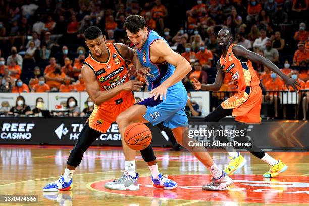 Scott Machado of the Taipans and Yannick Wetzell of the Breakers compete for the ball during the round 11 NBL match between Cairns Taipans and New...