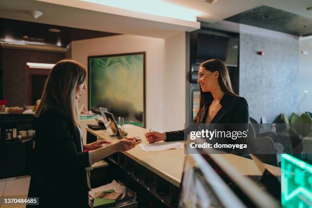 businesswoman at the hotel reception checking-in - advice woman travel traveling stock pictures, royalty-free photos & images