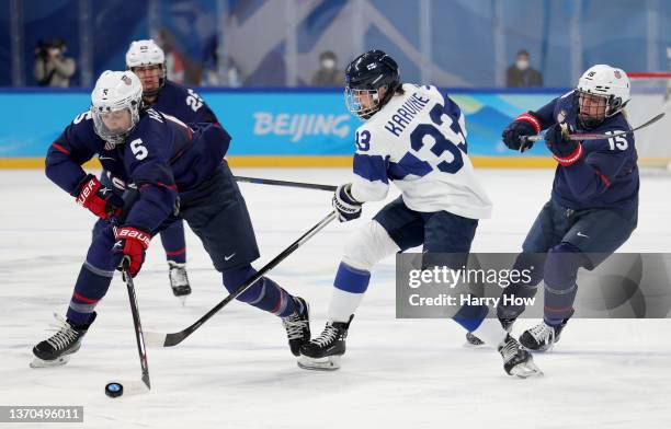 Defender Megan Keller of Team United States takes control of the puck from forward Michelle Karvinen of Team Finland in the first period during the...