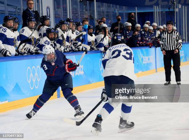 Defender Cayla Barnes of Team United States passes the puck as forward Michelle Karvinen of Team Finland defends in the first period during the...