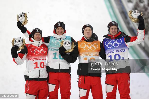 Stefan Kraft, Daniel Huber and Jan Hoerl and Maneul Fettner of Team Austria celebrate the Gold medal following the Men's Ski jumping Final Round on...
