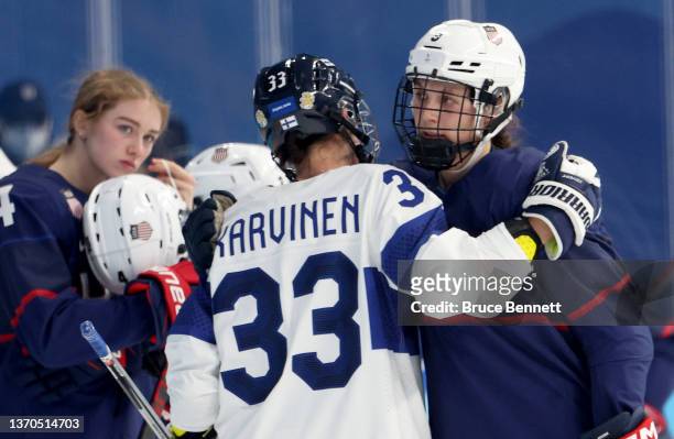 Forward Michelle Karvinen of Team Finland congratulates defender Megan Bozek of Team United States after their 4-1 loss during the Women's Ice Hockey...