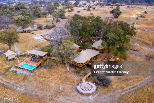 aerial view of the luxury tented reception and dining area with fire pit and swimming pool at tuludi safari camp,botswana - zeltplatz stock-fotos und bilder