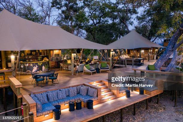 close-up aerial view of the luxury tented bar lounge and with sunken seating at tuludi safari camp,botswana - zeltplatz stock-fotos und bilder