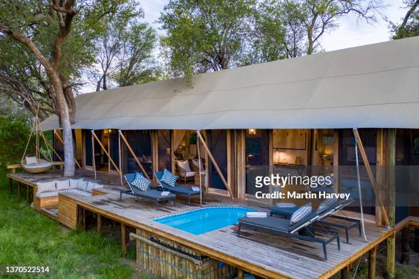 close-up aerial view of the exquisite luxury tented room with private swimming pool at tuludi safari camp, botswana - luxury tent stock pictures, royalty-free photos & images