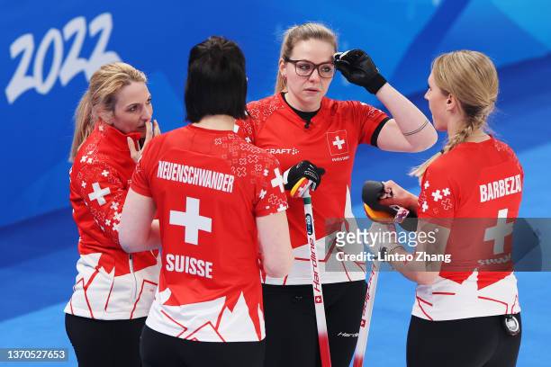 Silvana Tirinzoni, Esther Neuenschwander, Alina Paetz and Melanie Barbezat of Team Switzerland interact while competing against Team Sweden during...