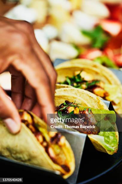 Medium close up shot of octopus tacos on table at outdoor restaurant