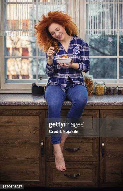 woman eating a healthy vegetarian meal - stir frying european stock pictures, royalty-free photos & images