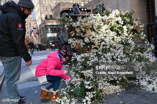 Alex Lohri , nine-years-old, and Spencer Gibson , both visiting from Wilmington, NC picks flowers from a flower installation at Rockefeller Center on...