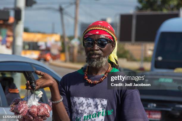 jamaican male street vendor selling food - jamaica people stock pictures, royalty-free photos & images