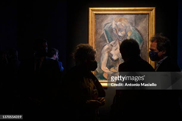 Visitors and journalists look at the painting "Young Lady" by Spanish painter Pablo Picasso, exhibited in Italy for the first time at the Rhinoceros...