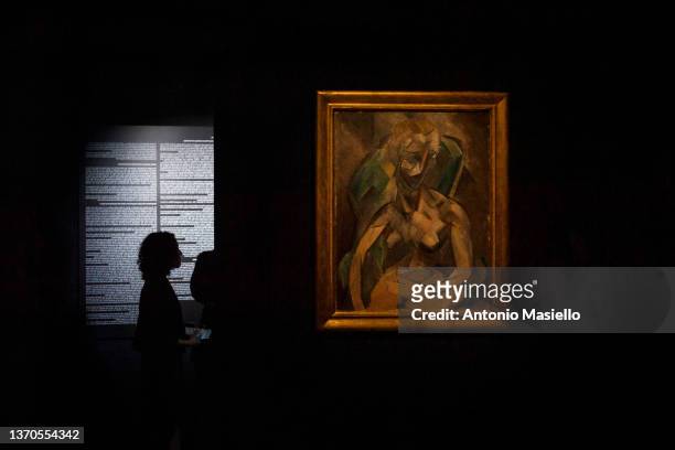 Visitors and journalists look at the painting "Young Lady" by Spanish painter Pablo Picasso, exhibited in Italy for the first time at the Rhinoceros...