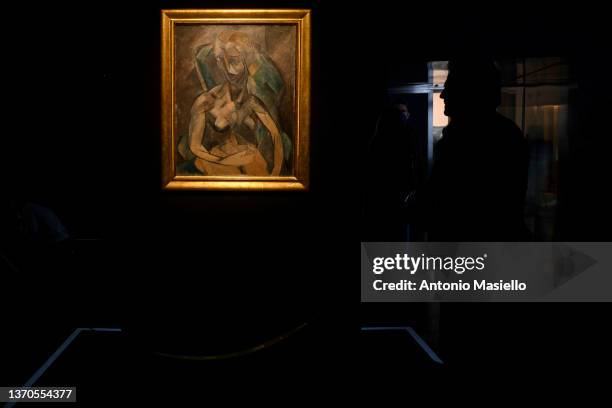 Visitors and journalists look at the painting "Young Lady" by Spanish painter Pablo Picasso, exhibited in Italy for the first time at the Rhinoceros...