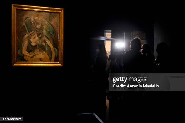 Visitors and journalists look at the painting "Young Lady" by Spanish painter Pablo Picasso, exhibited in Italy for the first time at the Rhinoceros...