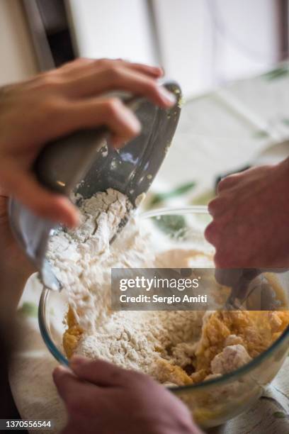 mixing flour and eggs with mashed potatoes in a bowl - prepared potato stock pictures, royalty-free photos & images