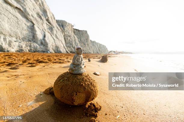 sand sculpture on a beach at dawn, greece - sand sculpture stockfoto's en -beelden