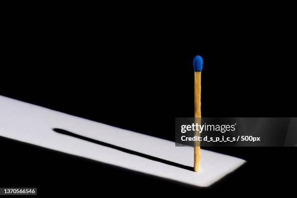 blue lantern,close-up of cigarette lighter against black background - matchstick stock pictures, royalty-free photos & images