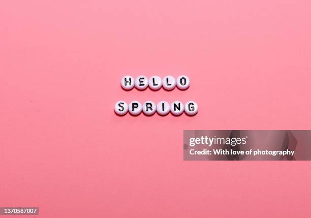 inscription hello spring letters  on pink paper background text - beads stock pictures, royalty-free photos & images