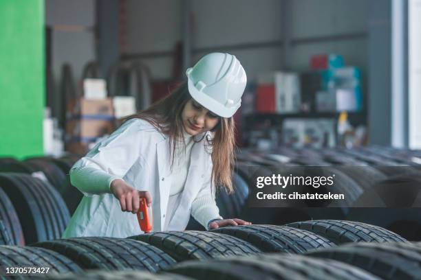 a female engineer checking a snow tire - funny mechanic stock pictures, royalty-free photos & images