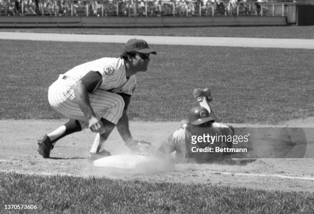 Manny Trillo of the Chicago Cubs looks up for the umpire's decision after Mets first baseman Joe Torre tagged him out in a pickoff play.