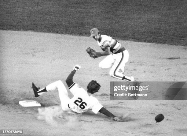 New York Mets' Dave Dingman slides into 2nd base and breaks up a double play, as he causes Houston shortstop Roger Metzger too high in the air for...
