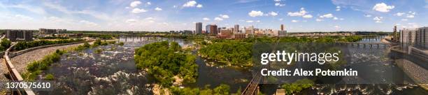 luftige skyline von richmond, virginia. der fernblick auf die innenstadt über den james river und die umliegenden parks und hölzernen naturgebiete. die eisenbahn auf der brücke. extra großes, hochauflösendes stitched panorama. - virginia stock-fotos und bilder