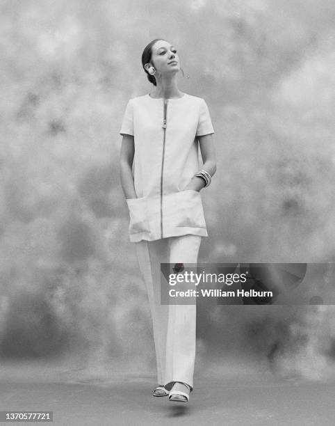 Portrait of American actress and model Marisa Berenson, in a short-sleeved, zippered blouse, trousers, and open-toed shoes, New York, New York, 1970.