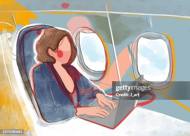 woman working in the plane on her laptop. - flugpassagier stock-fotos und bilder