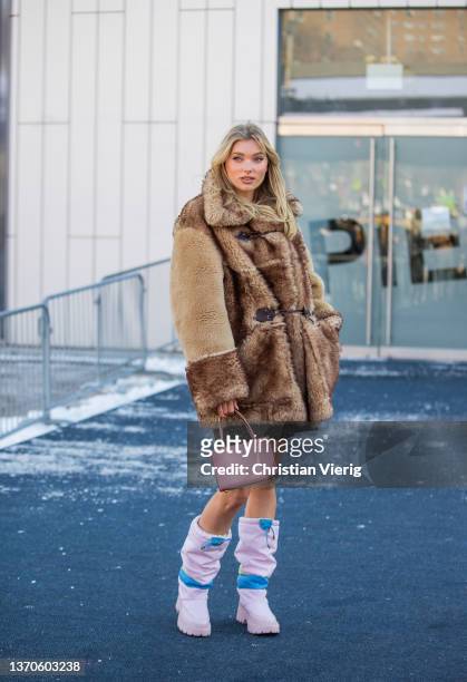 Model Elsa Hosk is seen wearing faux fur coat, pink bag, dress outside Coach during New York Fashion Week on February 14, 2022 in New York City.