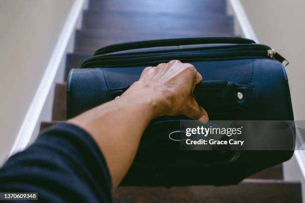 woman carries suitcase down staircase - name tag bildbanksfoton och bilder