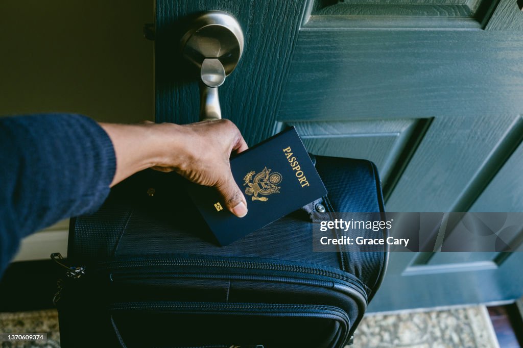Woman Prepares to Leave House With Packed Suitcase and Passport