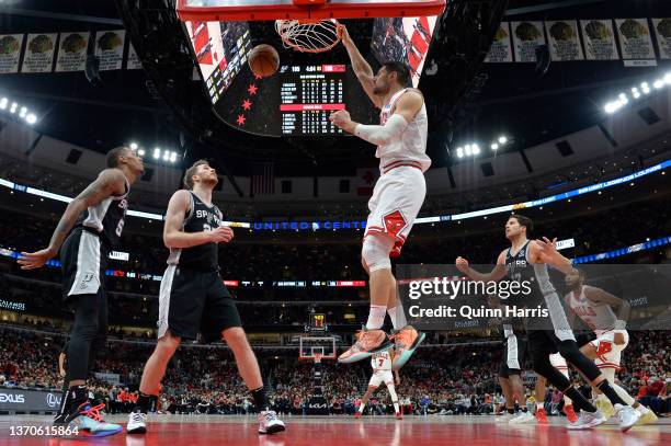 Nikola Vucevic of the Chicago Bulls dunks in the second half against Jakob Poeltl of the San Antonio Spurs at United Center on February 14, 2022 in...