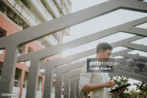 civil engineer drafting a blue print on his digital tablet. - flat inspection stock pictures, royalty-free photos & images