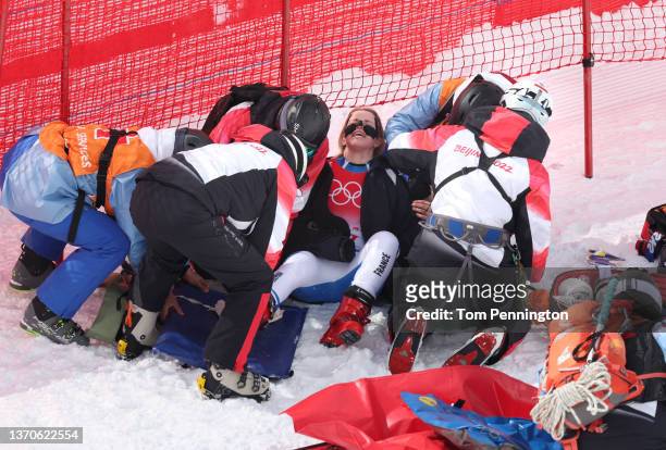 Medical staff attend to Camille Cerutti of Team France after she crashed during the Women's Downhill on day 11 of the Beijing 2022 Winter Olympic...
