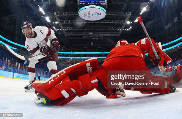 Lauris Darzins of Team Latvia scores a goal on Sebastian Dahm of Team Denmark in the first period of the Men’s Ice Hockey Qualification match between...