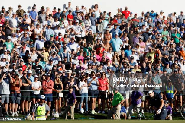 Patrick Cantlay of the United States chips onto the 18th green during the final round of the WM Phoenix Open at TPC Scottsdale on February 13, 2022...