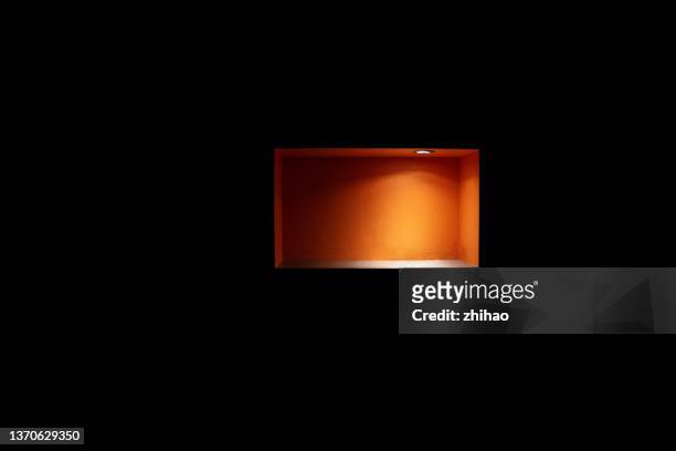 light effect of red storage space on black wall - skåp med glasdörrar bildbanksfoton och bilder