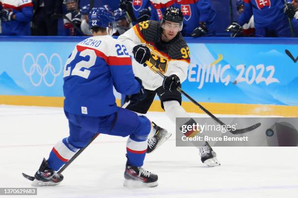 Marcel Noebels of Team Germany passes the puck past Samuel Knazko of Team Slovakia in the second period during the Men’s Ice Hockey Qualification...