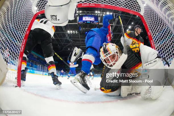 Goaltender Mathias Niederberger of Team Germany falls back into his net after failing to stop the puck from crossing the goal line on a goal by Libor...