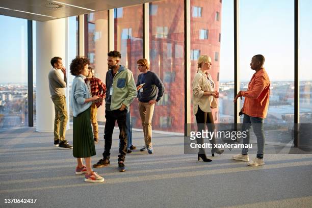 multiethnic group of business people standing and talking - stand bildbanksfoton och bilder