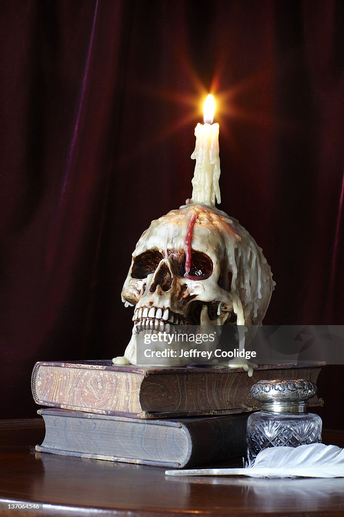 Candle and Skull on Books